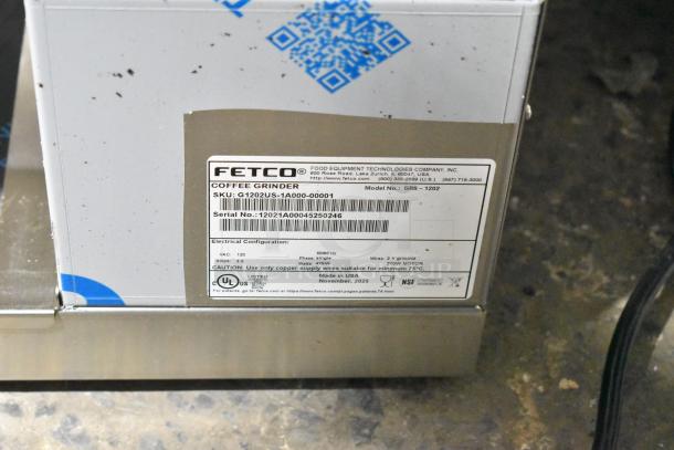 BRAND NEW SCRATCH AND DENT! 2025 Fetco GRS-1202 10 lb. Double Hopper Coffee Grinder, 120 Volts, 1 Phase. Visible label with model and serial number.