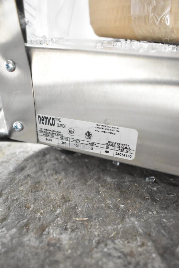 Brand new 2024 Nemco 6403 revolving pretzel warmer, dual rack, scratch and dent condition, missing glass, 120V, 1-phase.