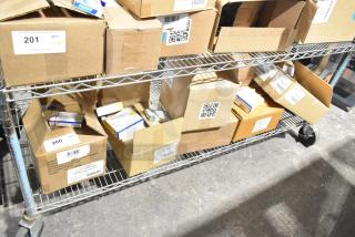 Boxes of medical supplies on a metal shelf, including gauze, masks, and gloves. Some boxes labeled with QR codes and item numbers.