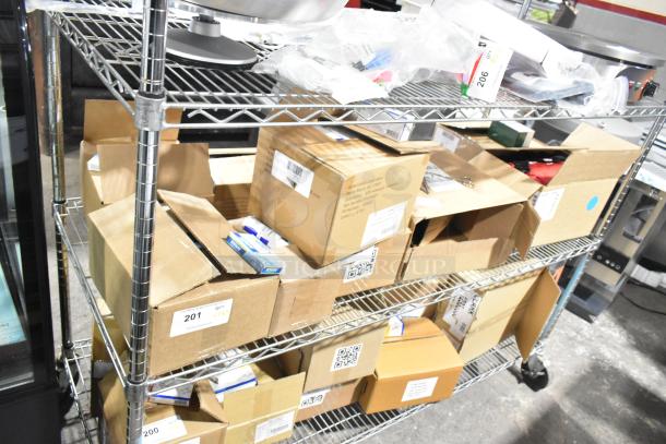 9 boxes of over-the-counter items, including antacid, aspirin, sting relief wipes, and cold pack. Scratch and dent condition. Tags visible.