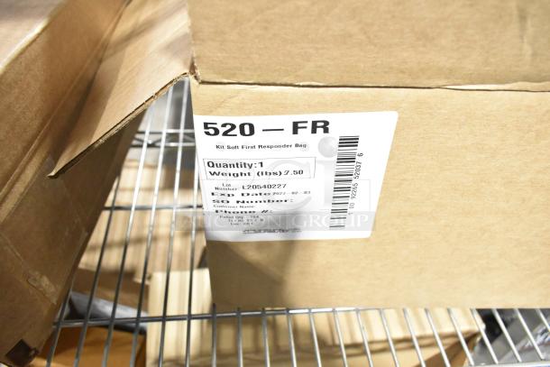 Cardboard box with label reading "520 – FR, Kit Soft First Responder Bag." Contains antacid, aspirin, wipes, cold pack.
