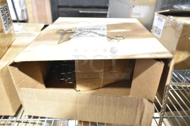 Nine brand new scratch and dent boxes on shelf containing antacid, aspirin, sting relief wipes, and a cold pack. Box labels visible.