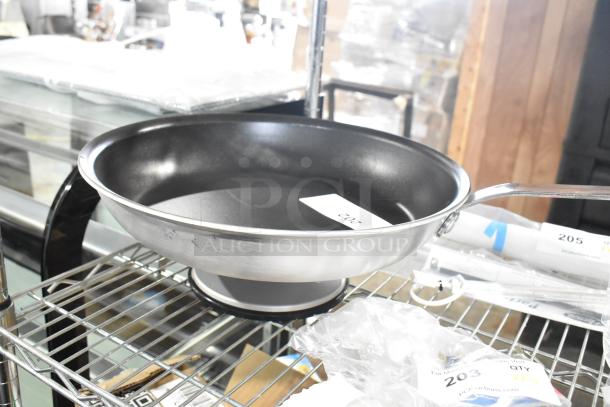 Vollrath 14" non-stick fry pan with rivetless interior, CeramiGuard II coating, black silicone handle, new condition.