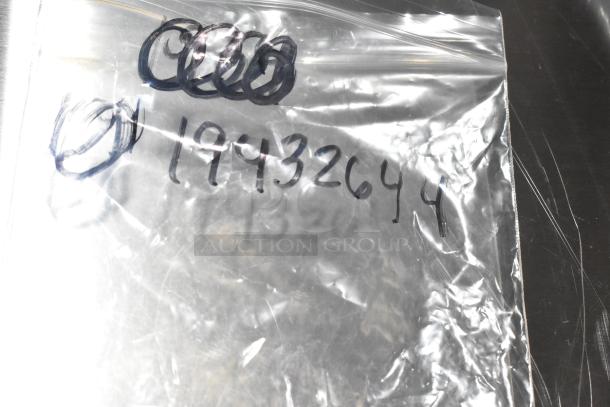 Plastic bag displaying handwritten number "1943264" and other markings, containing scratch and dent items including hinge and probe.