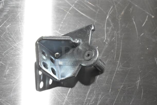 Metal hinge component, brand new, features multiple mounting holes and a pivot point, part of a scratch and dent auction lot.