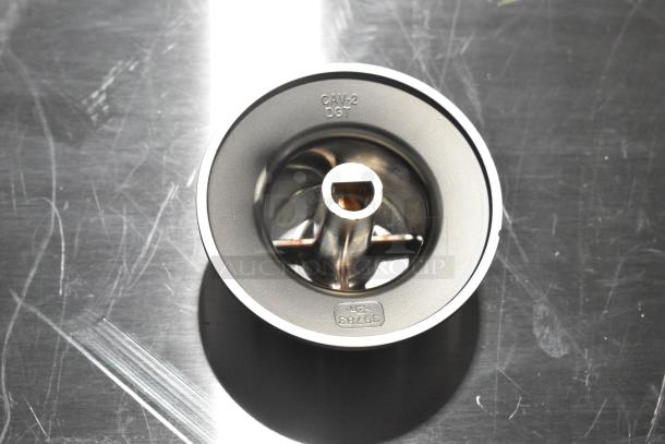 Metal component labeled "CAV-2 DGT" with part number "39783", showing minor scratches on surface.