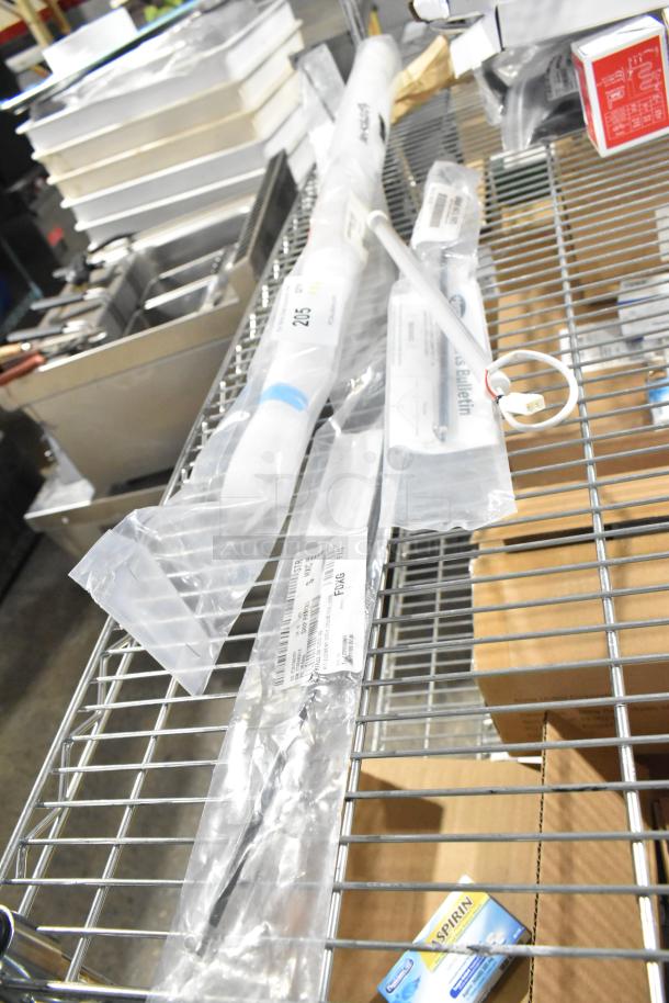 4 brand new scratch and dent heating elements, unopened in original packaging, with visible labels indicating model details.