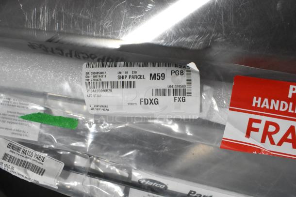 Four brand new scratch and dent items with heating elements, labeled as LED strips and Hatco parts. Fragile handling tags visible.