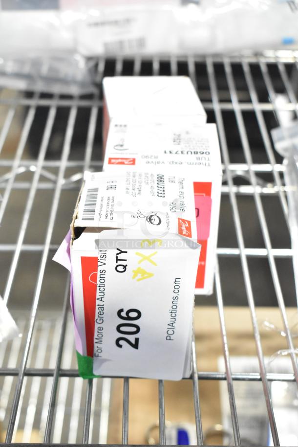 Three boxed expansion valves, brand new with scratch and dent notes, labeled with item and auction details.