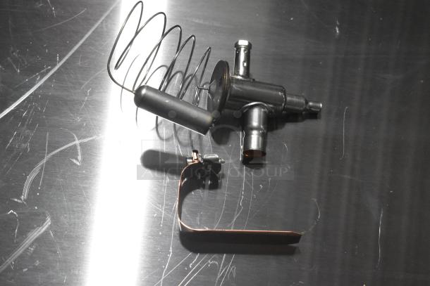 Three brand new scratch and dent expansion valves, key HVAC components, on a reflective surface showing minor marks.