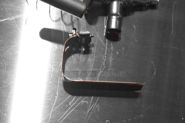 Three brand new scratch and dent items, including expansion valves, shown on a metallic surface.