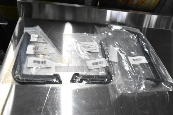 Three brand new scratch-and-dent door handles, each in sealed packaging, with visible barcodes and labels indicating quantity.