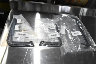 Three brand new scratch-and-dent door handles, each in sealed packaging, with visible barcodes and labels indicating quantity.