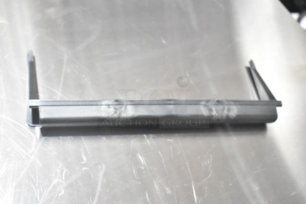 New scratch and dent door handle component, metal with minor blemishes, part of a lot of three items.