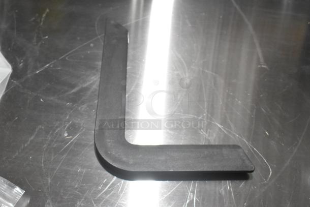 Black L-shaped door handle, new with minor scratches, on reflective surface. Includes 3 items; see description for full details.