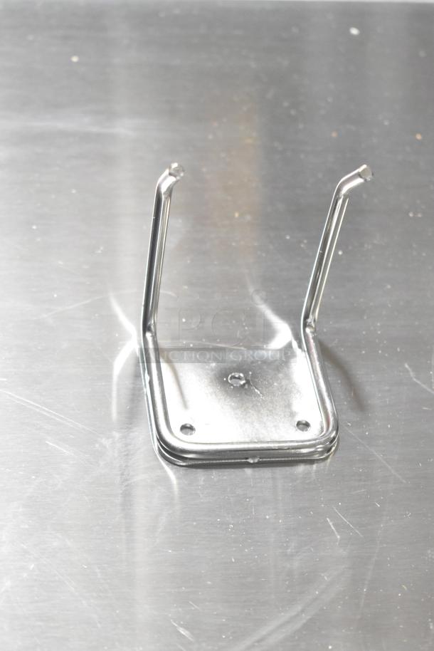 Chrome metal bracket on a stainless steel surface; no markings visible. Part of the AvaMix 928IBHD12 immersion blender package.