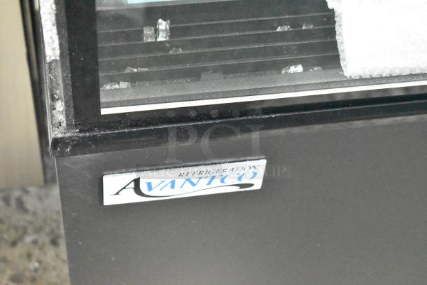 Avantco 193BC60HCB 60" refrigerated bakery display case with visible broken glass, black finish, curved glass design.
