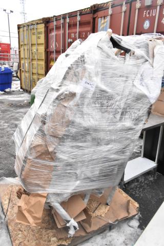 Plastic-wrapped pallet of scratch and dent items, including bar stools and Curtin traffic doors, with auction label reading "214 Bay OTT XTS."