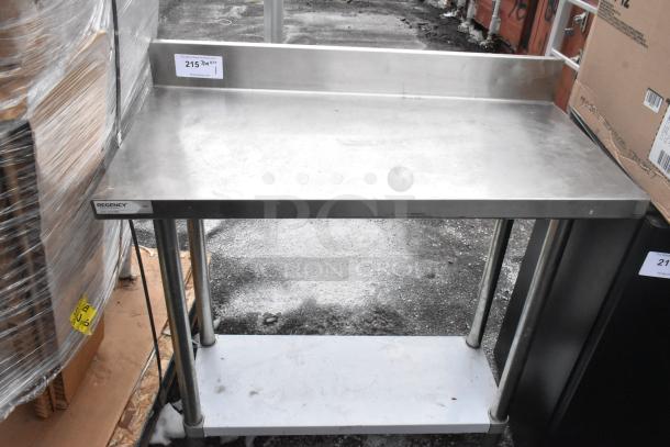 Regency 600TB1838G stainless steel table with backsplash and under shelf, moderate wear, label on front.