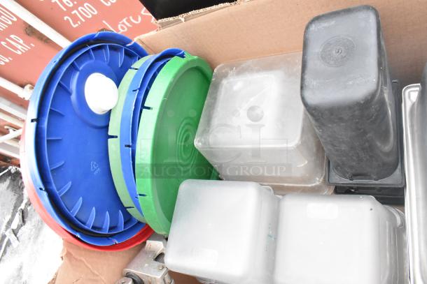 Lot of various items including colorful lids, Edlund knife holder, and clear drop-in bins in used condition.