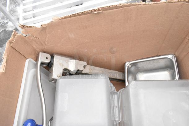 Lot of kitchen items including an Edlund knife holder, various drop-in bins, and a metal pan, all in used condition.