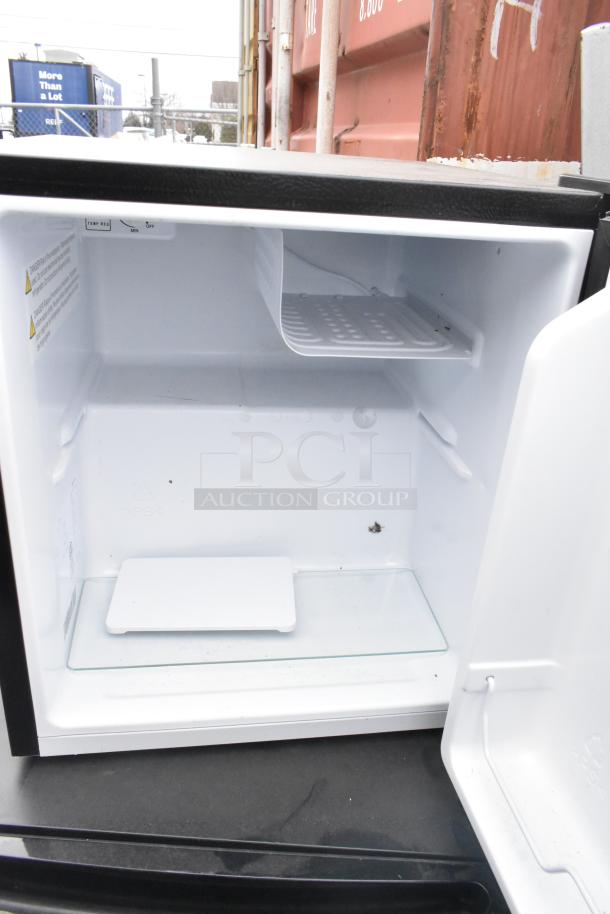 3 various mini coolers interior, including Galanz and Hisense models. 120 volts, 1 phase. Clean condition. Upper shelf visible.