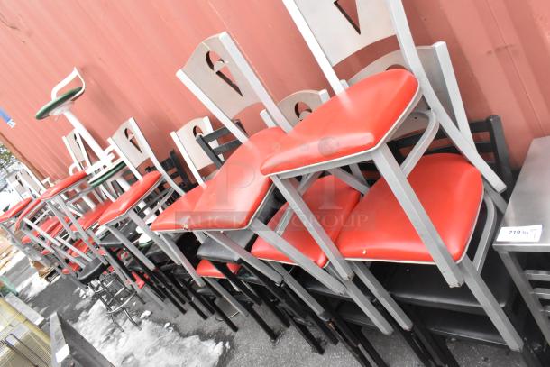 46 metal dining height chairs with red seat cushions, plus one green stool. Auction tag visible. Assorted styles.