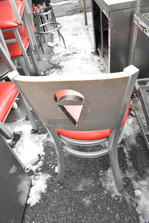 Metal dining chairs with red cushions, cutout design on backrest, fair condition. Includes 46 pieces for auction.