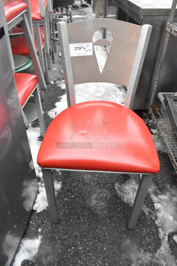 Metal dining chair with red seat cushion, silver frame; part of a lot of 46 chairs. Visible tag shows auction details.