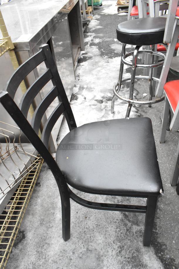 Black metal dining chair with slight wear, red seat cushion visible on adjacent chairs, part of 46-piece seating set.
