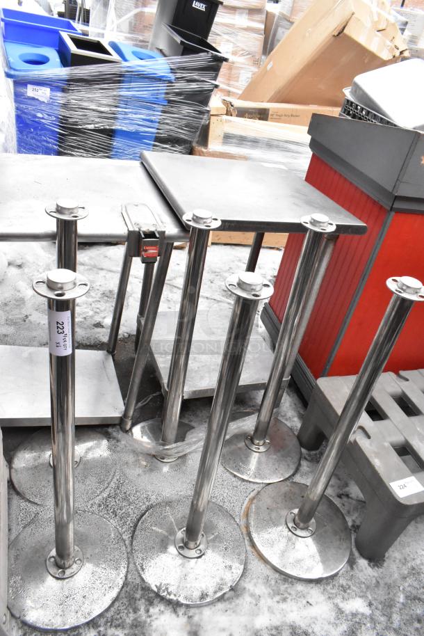 6 chrome finish stanchions, stainless steel, sturdy round bases, good condition. Label reads "223" indicating auction lot.