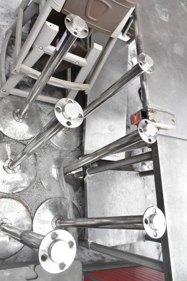 6 chrome finish stanchions, like-new condition, sturdy bases, suited for crowd control or event use, reflective surface.