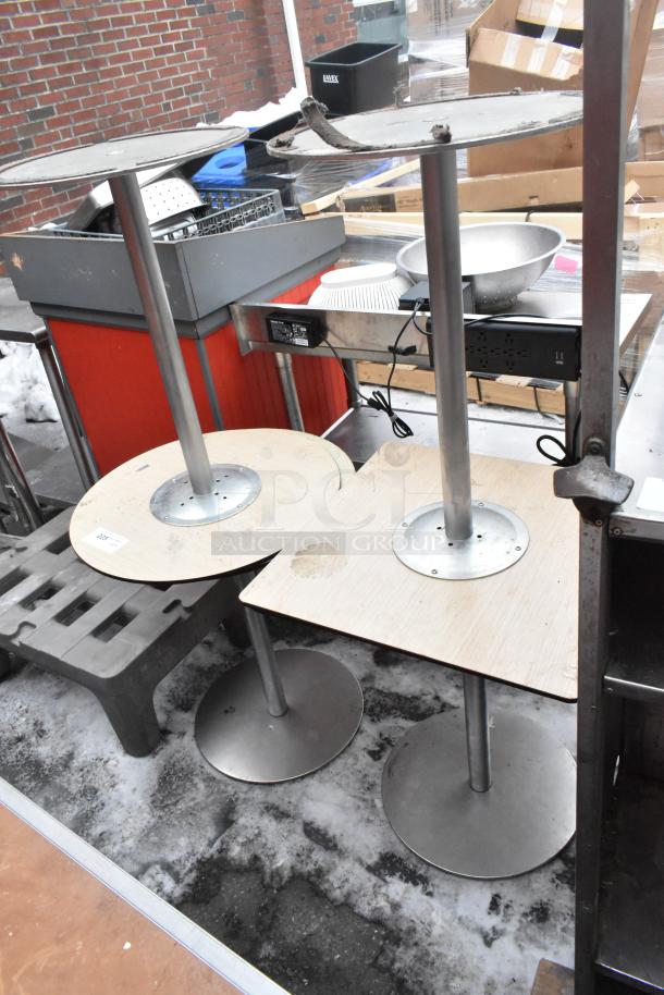 Four various tables with metal bases and wooden tops, showing wear. Ideal for refurbishing or parts.