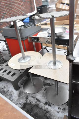 Four various tables with metal bases and wooden tops, showing wear. Ideal for refurbishing or parts.
