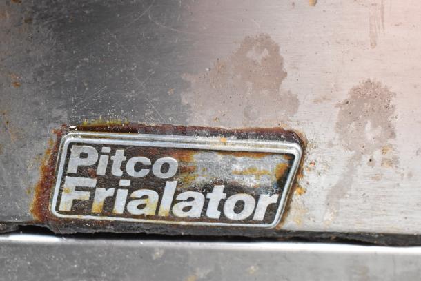 Pitco Frialator commercial gas fryer with two metal baskets. Features visible branding. Shows signs of use.