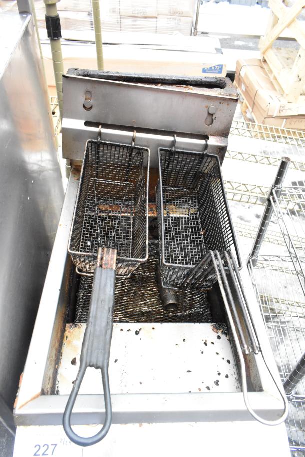 Pitco Frialator commercial gas fryer with two metal baskets, showing signs of use, suitable for large-scale frying.