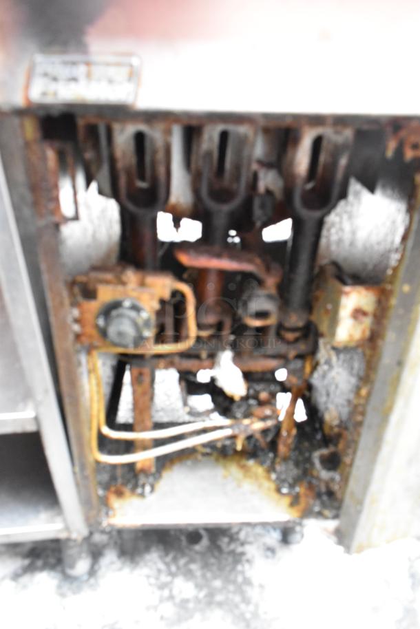 Pitco Frialator commercial gas fryer, floor style, with visible wear and rust; includes 2 metal fry baskets.