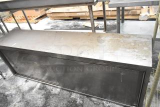 Stainless steel 2 door cabinet with visible surface wear and a sliding door. Industrial design, suitable for storage.