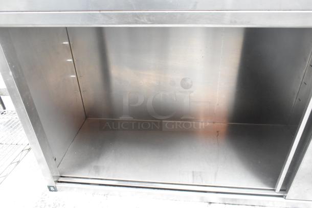 Stainless steel 2 door cabinet, open view, adjustable shelf slots, sturdy build, suitable for kitchen or garage use.