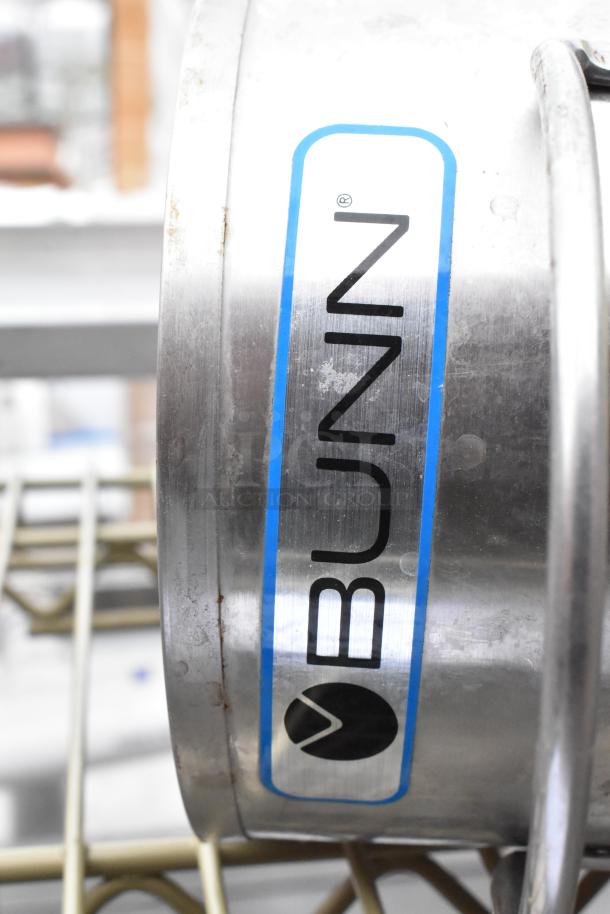 3 tier wire shelving unit with contents; visible Bunn label on metal item. Buyer must dismantle for shipping.