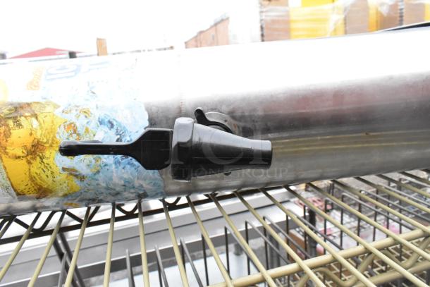 3-tier wire shelving unit with contents. Includes beverage dispenser with tap. Buyer must dismantle. Freight charges apply.