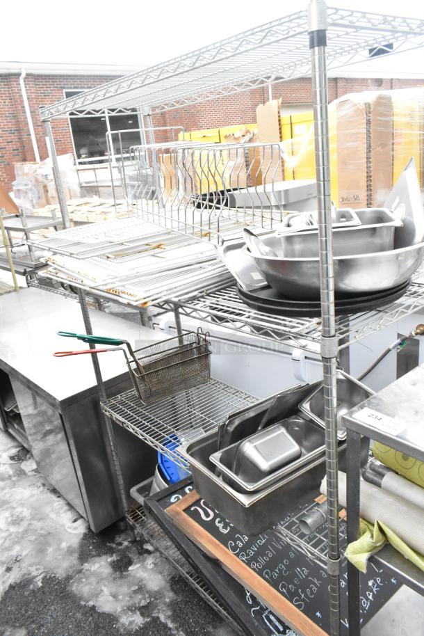 Chrome finish 4-tier wire shelving unit with bowls, drop-in bins, and signs. Good condition. Buyer must dismantle.