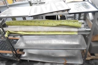 4-tier metal shelving unit with contents, including rolled fabrics and a signboard. Signs of wear visible.