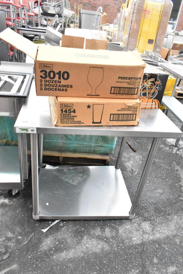 Regency 600TSB3036S stainless steel table with boxes labeled Libbey 3010 and 1454, containing glasses and bowls.