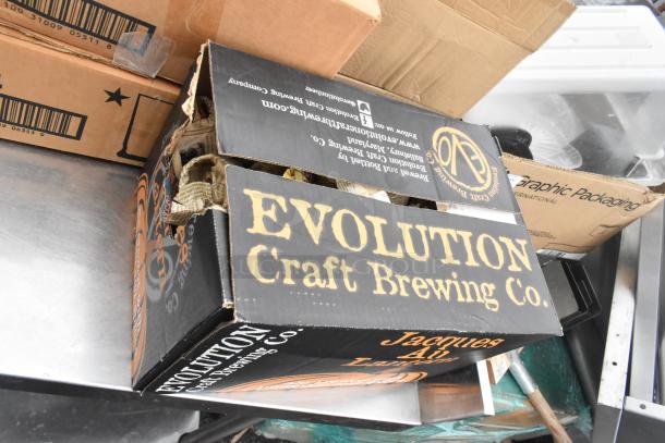 Regency 600TSB3036S table with various items, including a box with "Evolution Craft Brewing Co." label. Visible glasses and bowls.