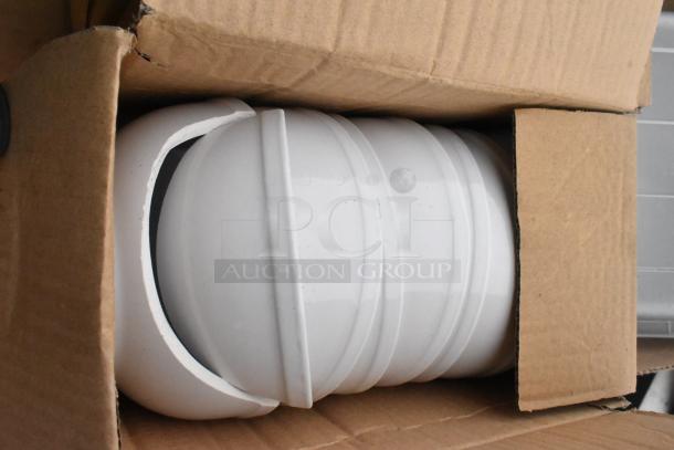 Cardboard box containing stacked white ceramic bowls, partially visible. Condition appears good, with no visible damage.