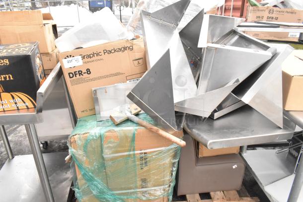 Pallet of assorted items including metal shelves, poly bins, bowls, and table base posts. Some packaging visible.