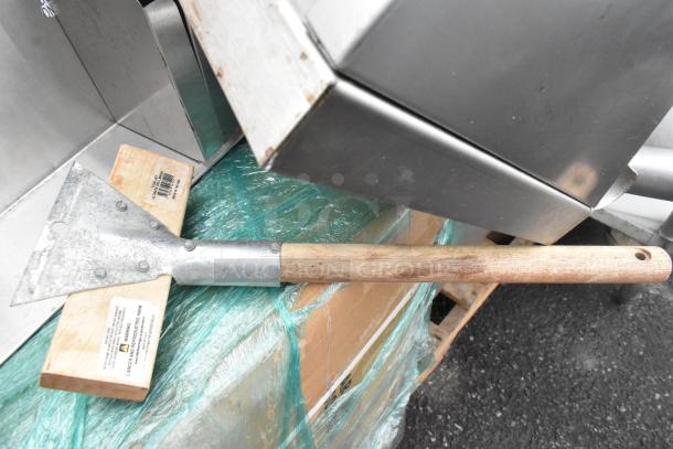 Pallet with metal shelves, wood posts, metal tool with wooden handle, and wrapped items. Labels indicate potential hazards.