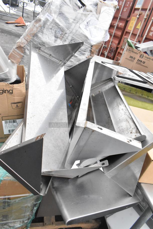 Pallet lot of metal shelving units, poly drop-in bins, bowls, and table base posts. Items appear used with visible wear.