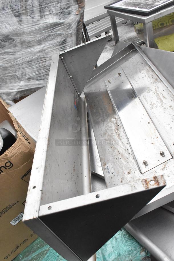 Pallet containing various items: metal shelves, poly drop-in bins, bowls, and table base posts. Some items show signs of wear.